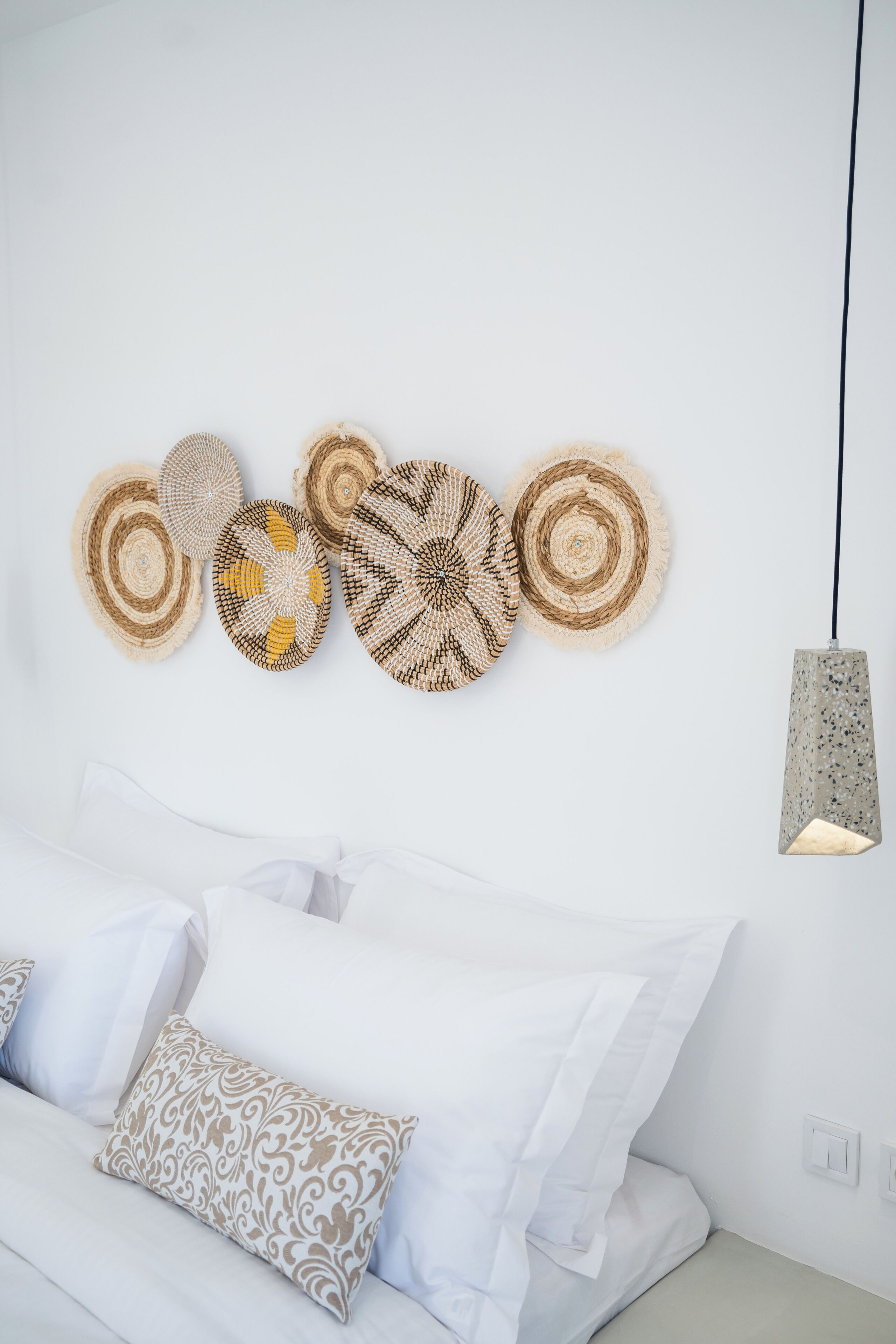 Une chambre à coucher avec un lit, des oreillers et des éléments de décoration murale.