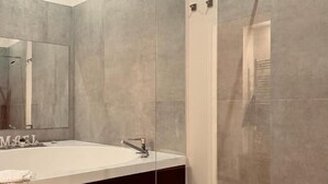 A modern bathroom with a glass-enclosed shower, a large mirror, and a dark-toned vanity. - MAEL SUPERIOR ROOM (Palermo)