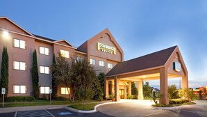 A Staybridge hotel with a modern design, featuring a prominent entrance and a well-lit facade. - Relaxing Retreat Near Angelo State University! Shared Outdoor Pool (San Angelo)