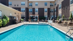 A swimming pool with lounge chairs and a pergola in a courtyard of a multi-story building. - Studio Near Denver Tech Center | Free Weekday Shuttle + Breakfast! (Centennial)