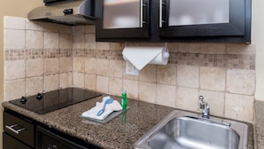 A kitchen with granite countertops, a stainless steel sink, a dish rack, and a dish soap bottle. - Studio Near Denver Tech Center | Free Weekday Shuttle + Breakfast! (Centennial)