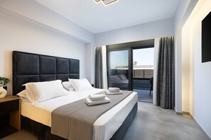 A modern hotel room with a large bed, a bedside table, and a view of the outside.