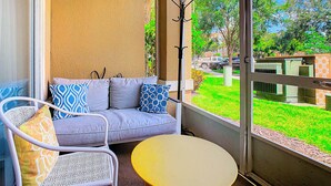 A balcony with a sofa, chairs, and a table. - ToyStory - Poolside/Water park Gound Level next to Disney (Kissimmee)