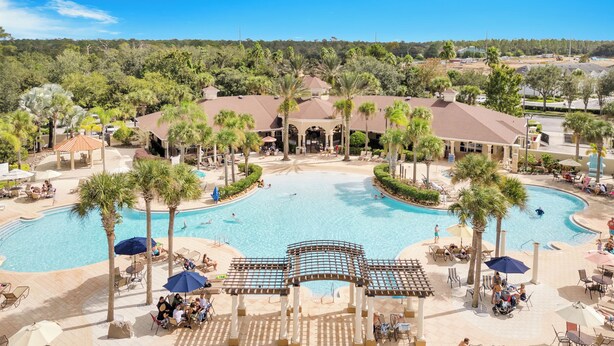 A resort with a central pool, palm trees, and outdoor seating areas. - ToyStory - Poolside/Water park Gound Level next to Disney (Kissimmee)