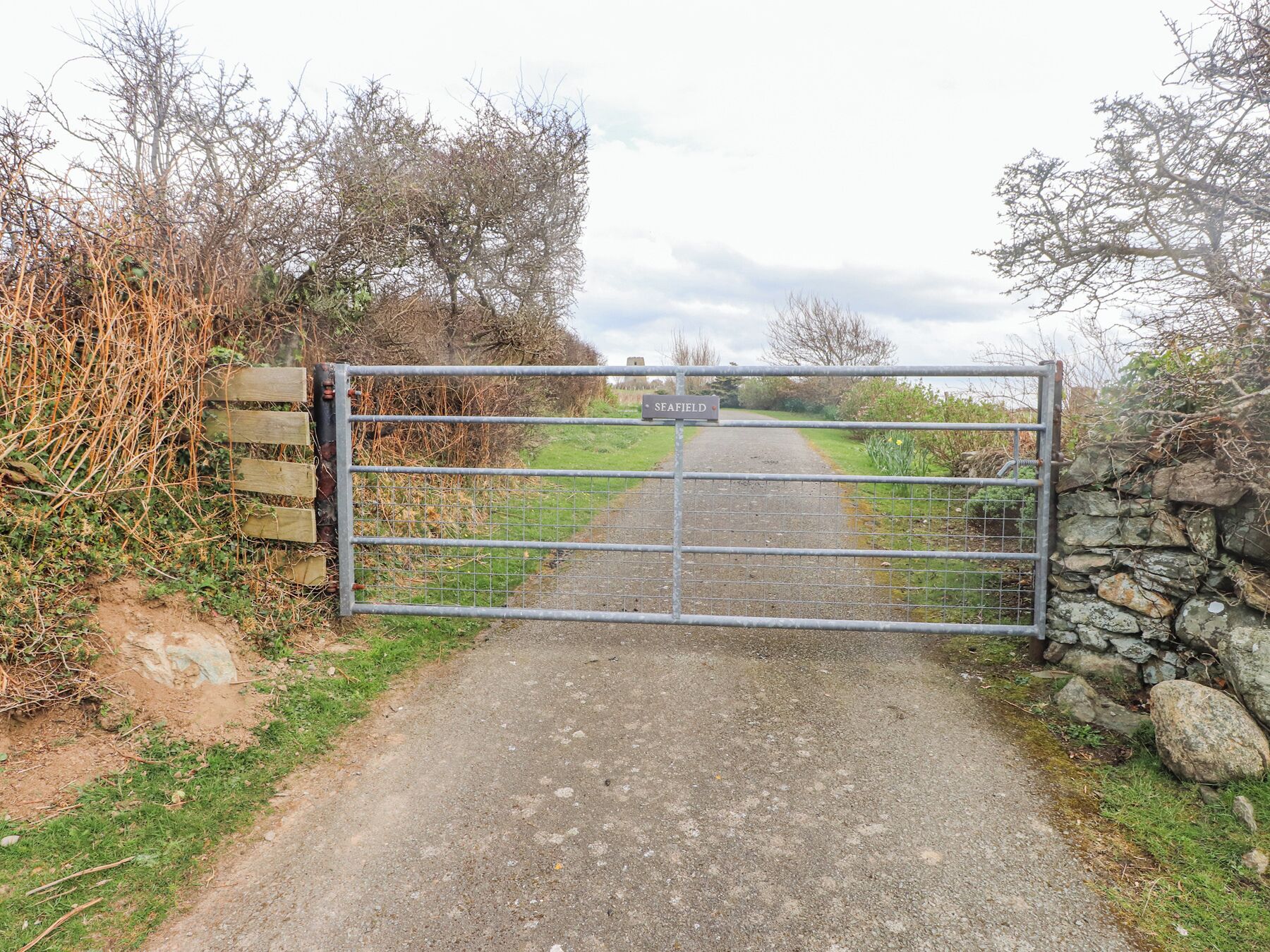 A gated entrance to a rural area with a sign reading "SEAFIELD".