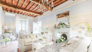 A spacious living room with a fireplace, comfortable seating, and decorative elements.