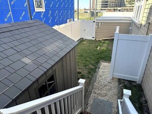 A residential area with a house, a fenced yard, and a building under construction. - Now avail Beach Block Getaway (Atlantic City)