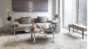A modern living room with a sofa, coffee table, and a large painting on the wall. - Point Grey Newly Constructed Estate (Vancouver)