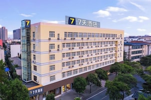 A multi-story hotel with a prominent '7' sign on the facade, indicating it is the 7th hotel in a series.