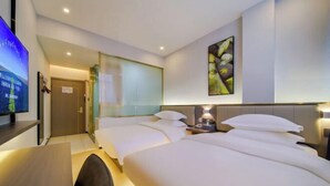 A hotel room with two beds, a desk, a TV, and a painting on the wall. - 7Days Inn Hotel (Zhoukou Wuyi Square City Central Hospital) (Zhoukou)