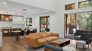 A modern living space with a kitchen, dining area, and seating area.