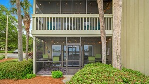 A two-story building with a balcony, outdoor seating area, and a covered entrance. - Seascape Boardwalk Villa 199*5 minute walk to beach! (Miramar Beach)