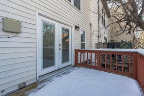 Stunning home with a cozy red deck and a welcoming entrance.