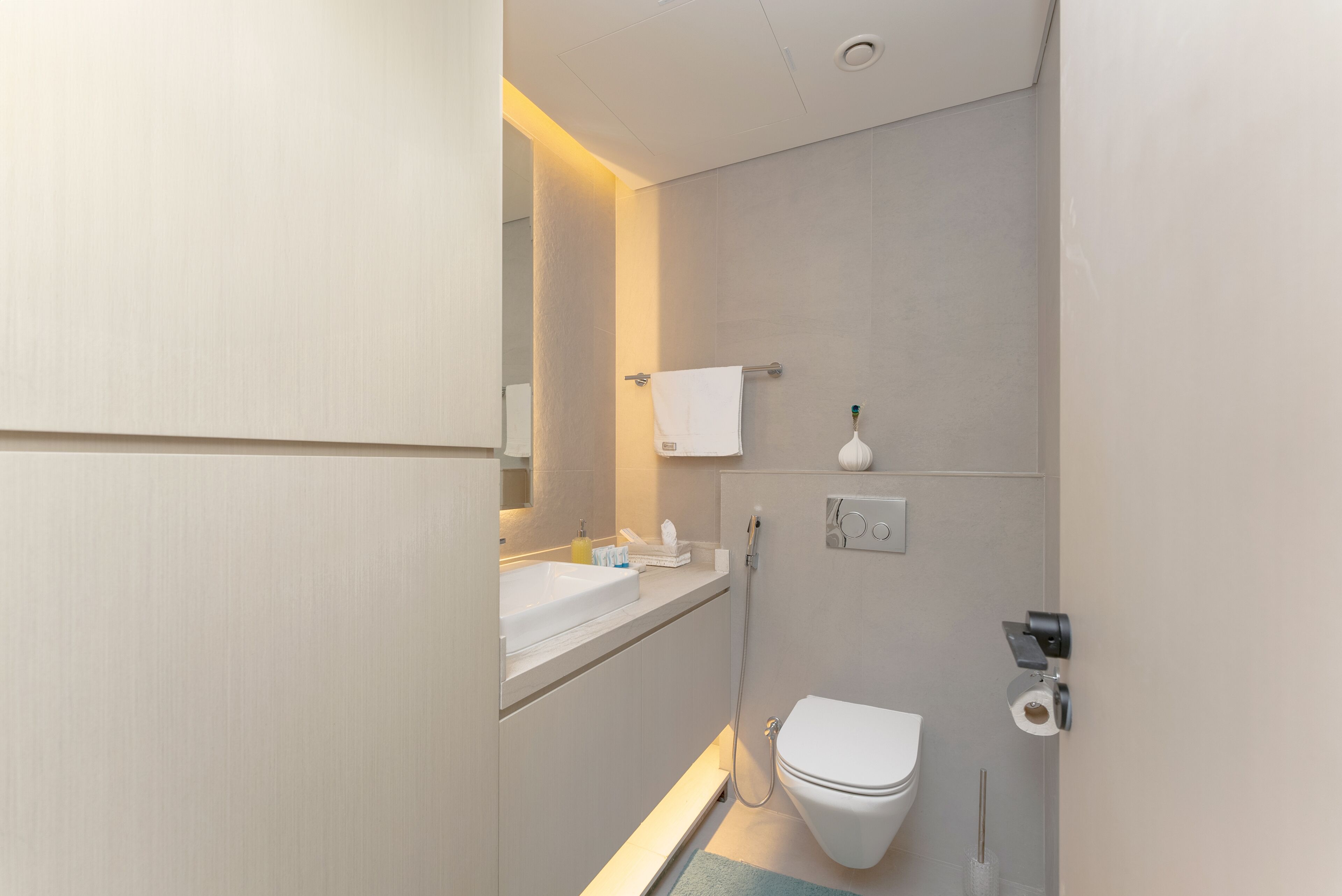 A modern bathroom with a sink, toilet, and shower.