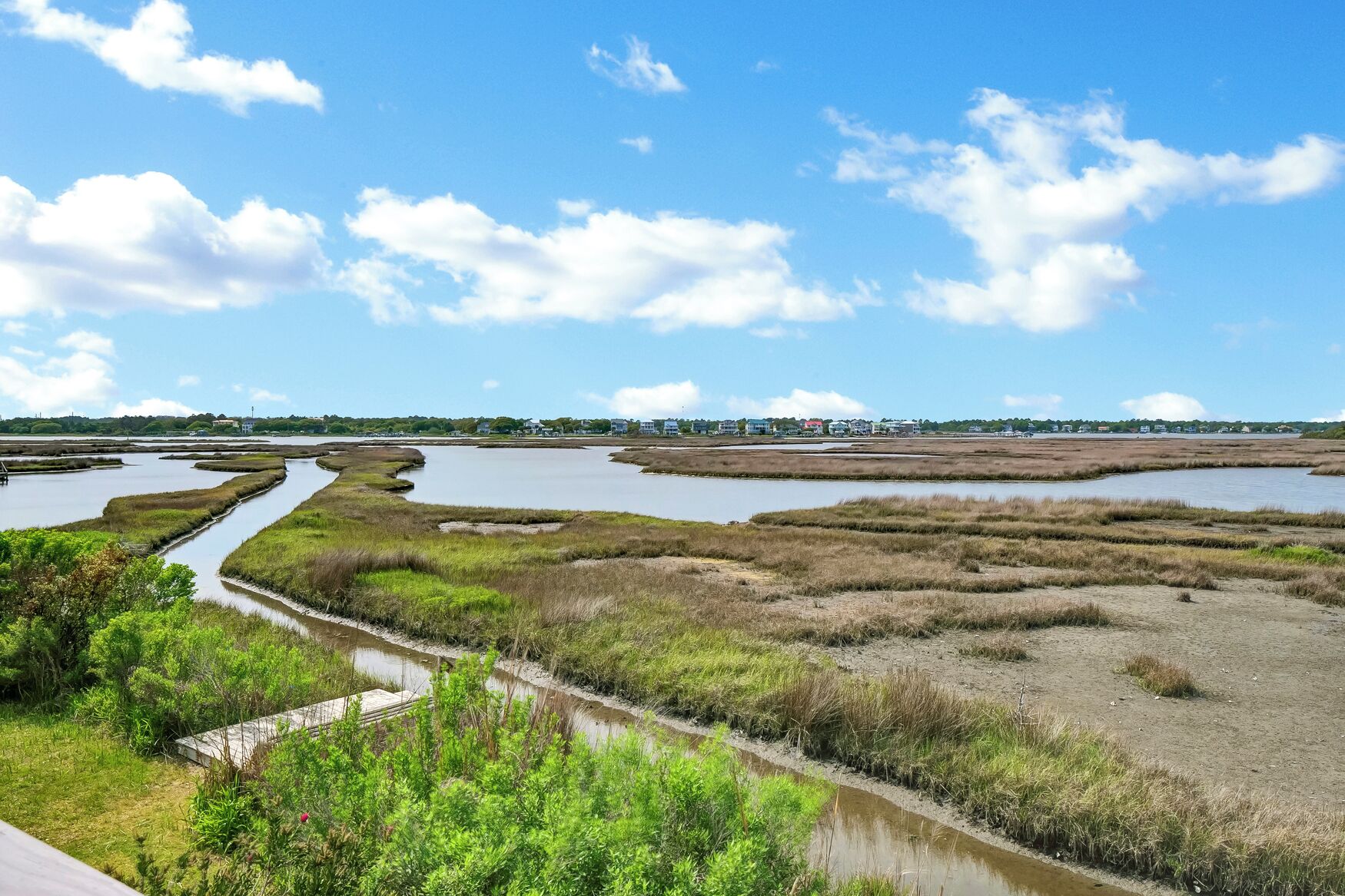 A coastal landscape with a network of water channels and marshy areas.