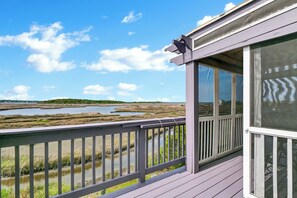 A wooden deck with a view of a marshy landscape and a body of water. - Waterfront Stay w/ Stunning Views, Beach Access, Outdoor Shower & Lift (North Topsail Beach)
