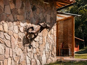 A stone wall with a mounted sculpture of a deer.