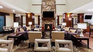 A spacious lobby with a stone fireplace, comfortable seating, and a flat-screen TV. - Free Breakfast. Outdoor Pool. King Suite Close to the Convention Center (Fort Worth)