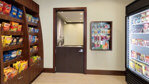 A snack and beverage vending area with various brands of chips and a refrigerated section with drinks. - Free Breakfast. Pool. Quick Drive to the new Chevron and Oxy campuses! Great for Business Travelers! (Midland)