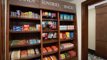 A candy, sundries, and snacks display with various packaged goods.