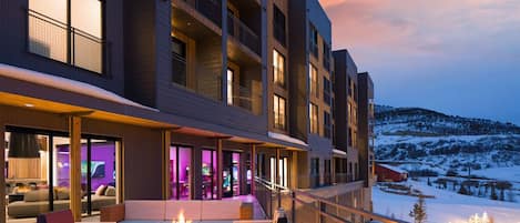 Enjoy the scenic views from your balcony with seating and a cozy fire feature.