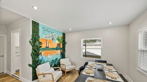A dining area with a mural, wooden flooring, and a table set for six. - Family-Friendly 3BR | Downtown & Lake Hollingsworth (Lakeland)