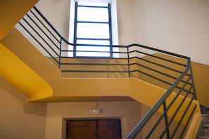 A multi-level interior with a staircase, a window, and a door.