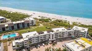 A resort with multiple buildings, a swimming pool, and a beach. - Direct Gulf Front Ground Floor Condo | Steps to the Gulf and Pet-Friendly (Sanibel)