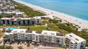 A beachfront hotel with multiple buildings, a swimming pool, and a beach. - Direct Gulf Front Ground Floor Condo | Steps to the Gulf and Pet-Friendly (Sanibel)