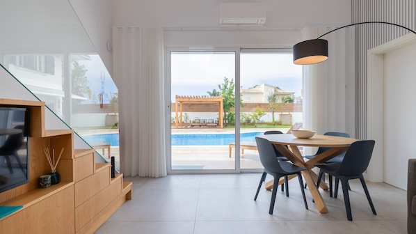 Enjoy meals in the dining area with a sliding door leading to the outdoor space.