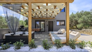 A modern outdoor patio with a pergola, seating area, and a small pool. - Rosy pair,private pool & jacuzzi near waterpark & Beach (Anopolis)