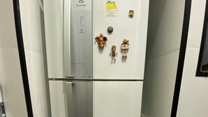 A white refrigerator with a glass door, a control panel, and decorative magnets. - Lapa the Bohemian Neighborhood of Rio. The Wonderful City with Comfort and Safety. (Centro Rio de Janeiro)