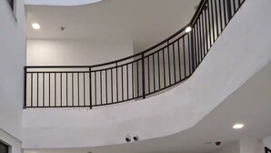 Ein mehrgeschossiges Interieur mit Balkonen, Geländern und eingelassener Beleuchtung.