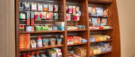 A well-organized pantry with various food items and beverages.