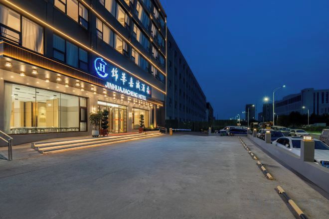 A hotel entrance with a modern facade, large windows, and a well-lit entrance area.