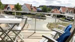 A balcony with a view of a street and houses. - Well-kept Corner Apartment in Koksijde (Koksijde)