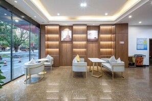 A hotel lobby with seating, a reception desk, and a view of the street. - Jingtu Hotel (Beihai Hunan Road) (Beihai)