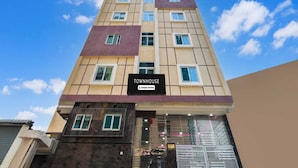 A multi-story building with a sign reading 'TOWNHOUSE.' - Classic Kokapet Near GAR (Hyderabad)