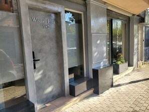 A hotel entrance with a frosted glass door labeled "Wanda Luxe 182". - Wander Luxe  (Tirana)