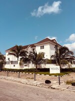 A two-story building with a sign reading "MISAN".