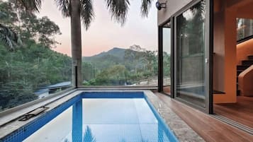 Swim surrounded by a lush landscape and mountain views.