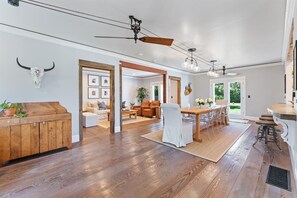 Relax in this stylish space with a large dining table, seating area, and fully equipped kitchen.