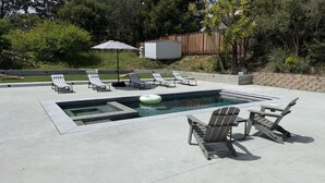 A swimming pool with lounge chairs and a floating ring. - Beautiful 4 BD home, 1.5 Miles from the Beach (Soquel)