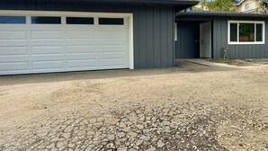 A single-story building with a garage, a small attached structure, and a gravel driveway. - Beautiful 4 BD home, 1.5 Miles from the Beach (Soquel)