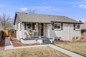 A single-story house with a front porch, a small garden, and a visible mailbox. - Cozy Garden Suite by Sloan's Lake and Tennyson! (Wheat Ridge)