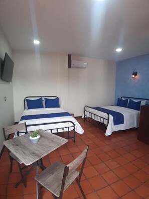 Standard Quadruple Room, Balcony, Courtyard View | In-room safe, desk, laptop workspace, free WiFi