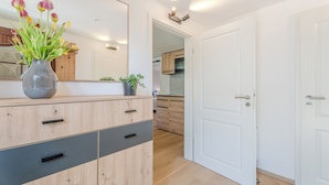A modern kitchen with wooden cabinets and a white door.