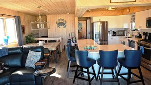 Un intérieur chaleureux comprenant un coin repas, une cuisine et un espace salon.