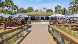 A beachside restaurant with outdoor seating and a brick pathway leading to the entrance. - Sala Suite 1! Monday & Thursday Fall Promo! Pet Friendly, Walk to Beach! (St. Pete Beach)