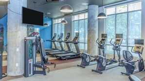 A gym with treadmills, elliptical machines, and weight machines. - Distinct Houston Luxury Downtown W/kingbed (Houston)
